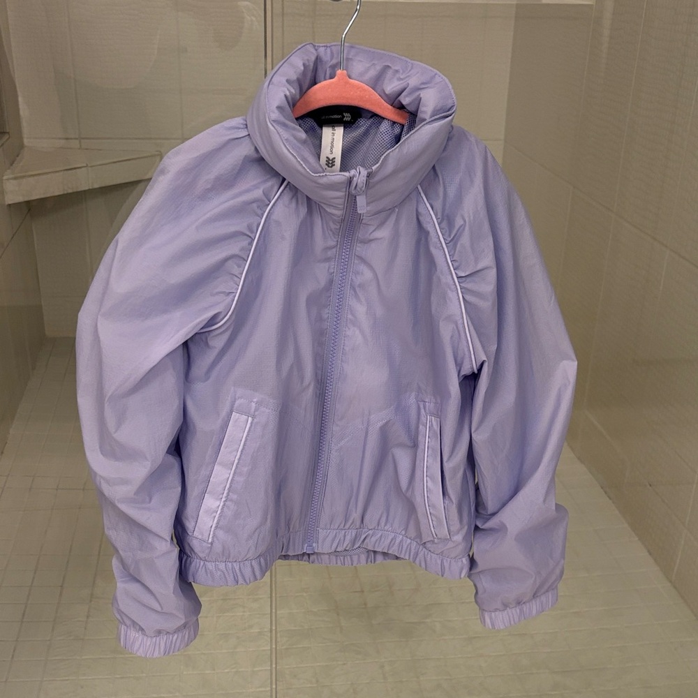 Girls All  in motion Lavender Mesh-Lined windbreaker with packable hidden hood.